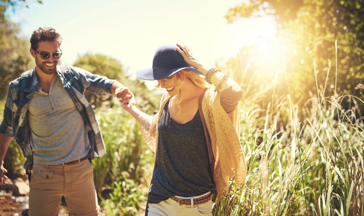 happy couple hiking in the woods