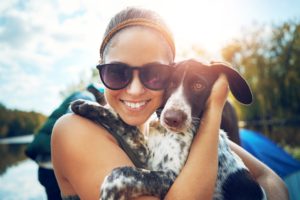 woman with dog by a lake