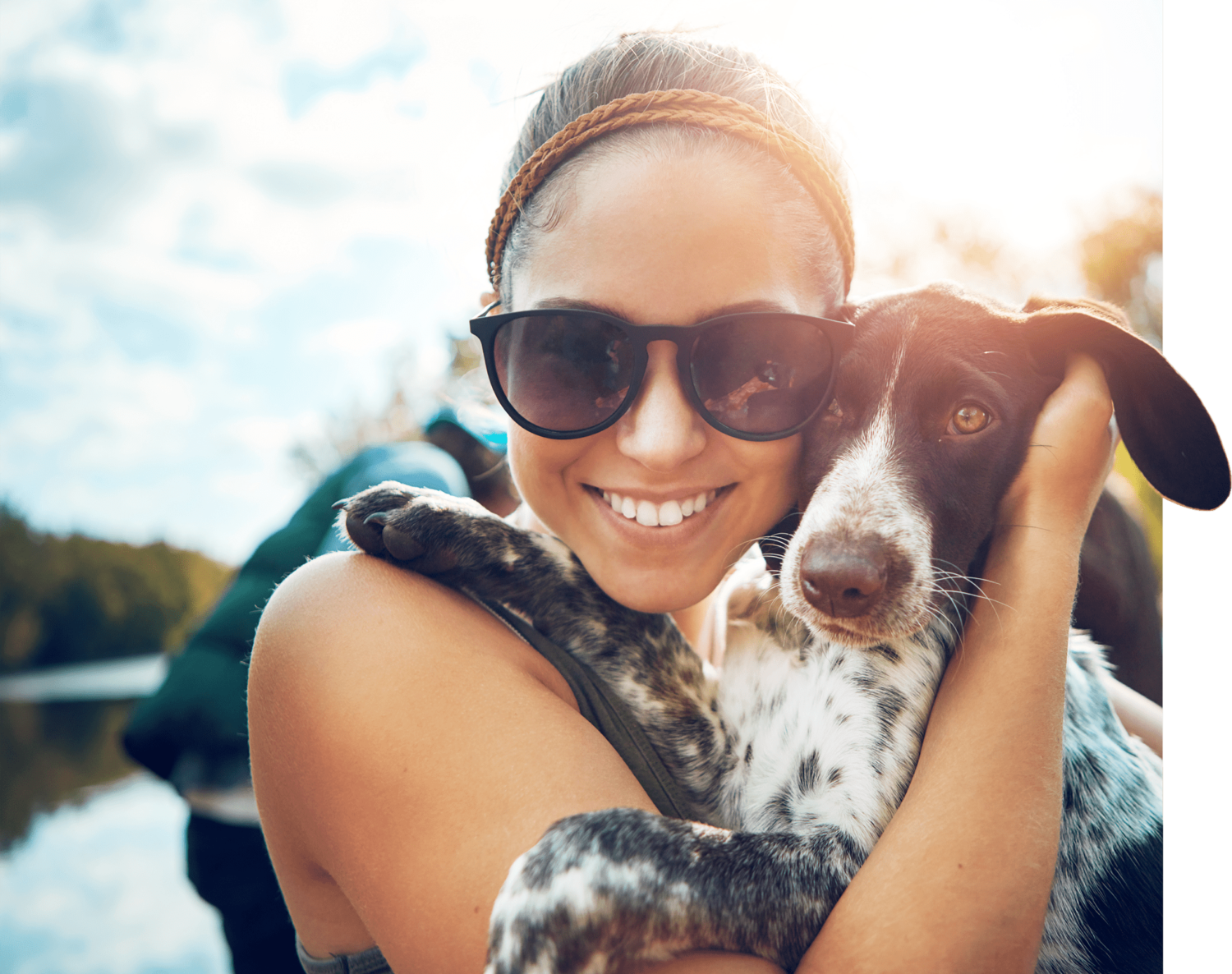 woman with dog by a lake