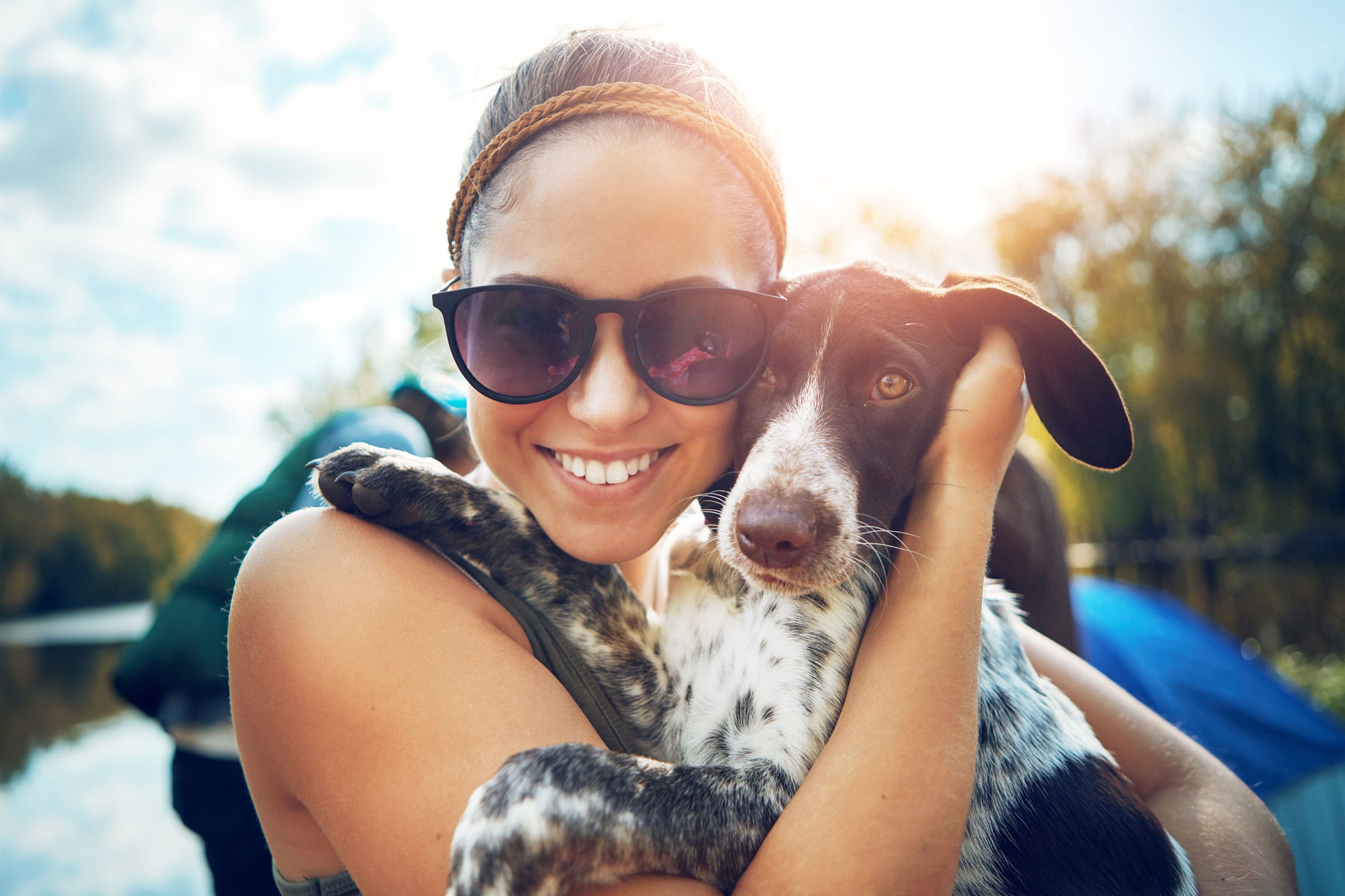 woman with dog by a lake