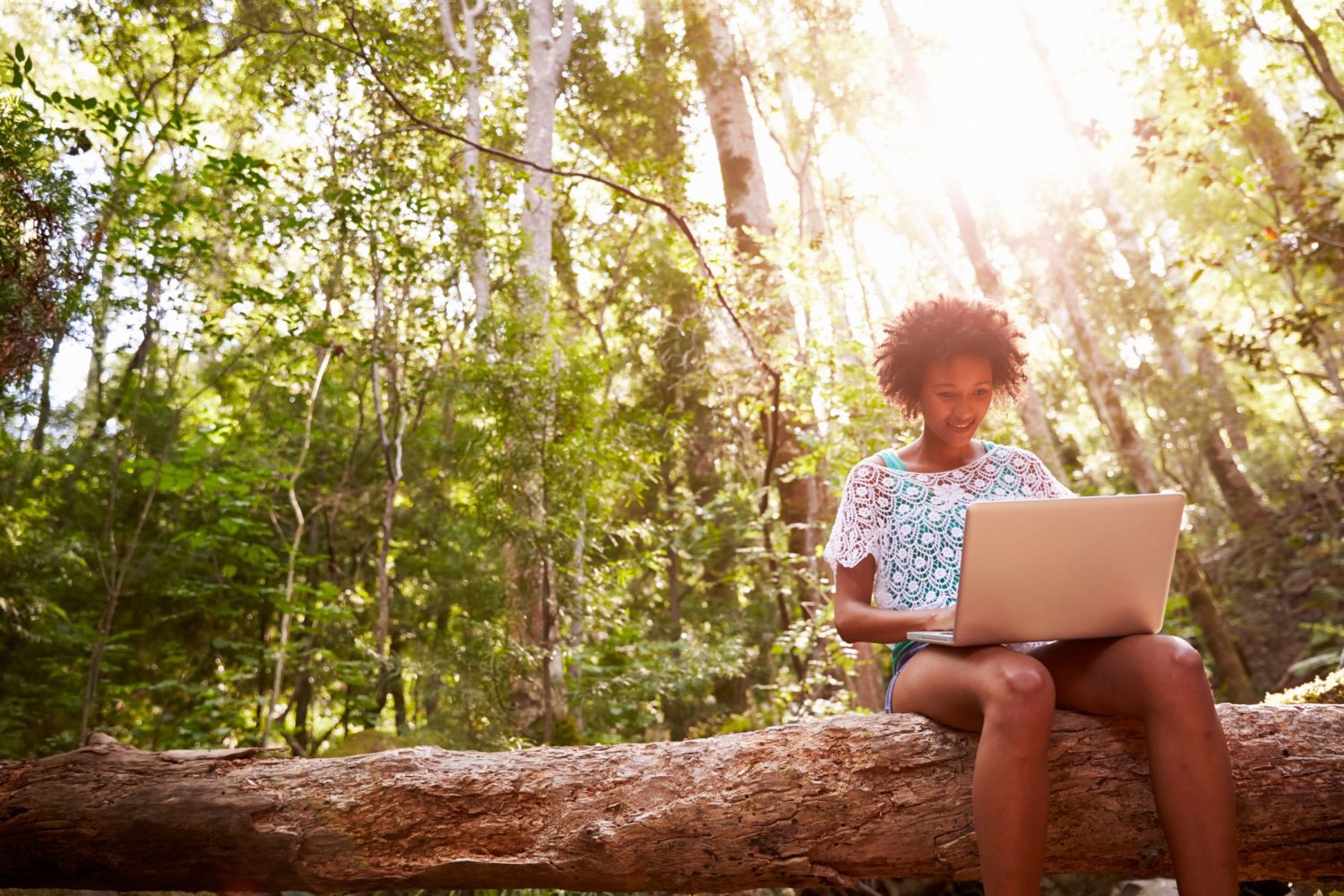 woman sitting outside with a laptop