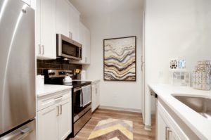 Kitchen with stainless steel appliances and tile backsplash