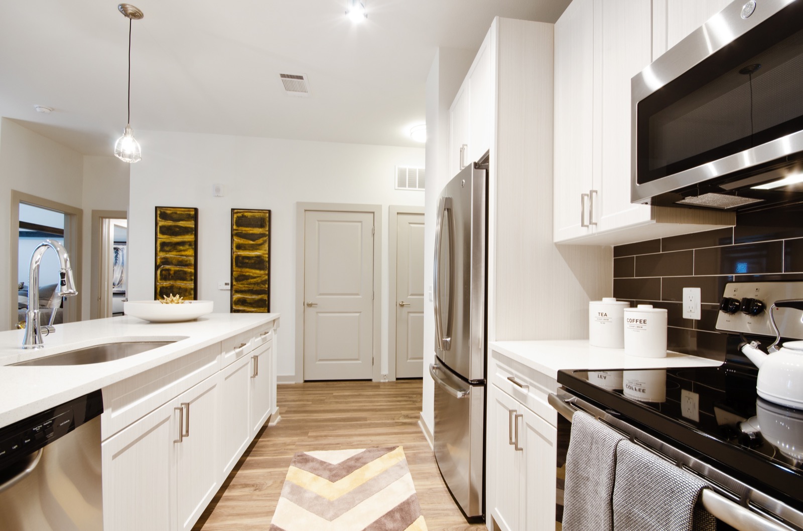 Kitchen with stainless steel appliances and tile backsplash
