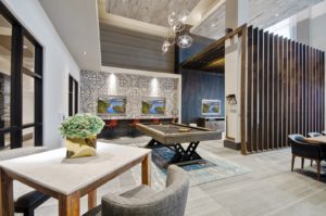 Community lounge with sofas and chairs and billiards table