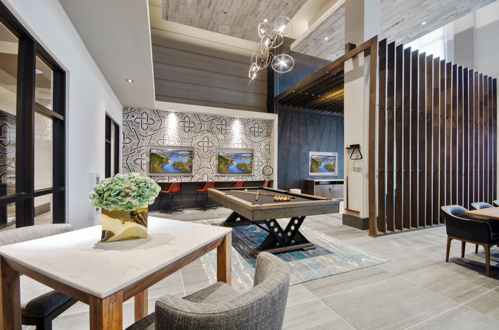 Community lounge with sofas and chairs and billiards table