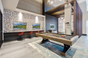 Community lounge with sofas and chairs and billiards table