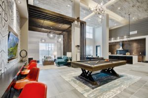 Community lounge with sofas and chairs and billiards table