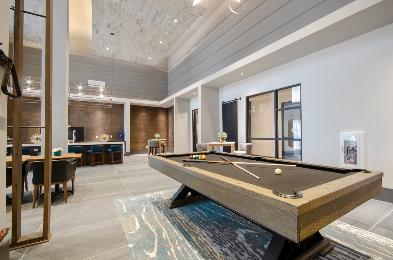 Community lounge with sofas and chairs and billiards table