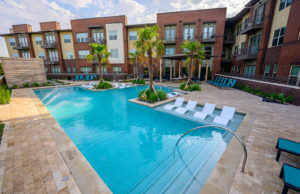 Pool with deck seating and private cabanas